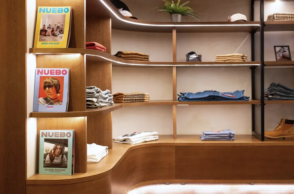 Estantería curva con revistas y ropa doblada, tienda Kaotiko, Manresa